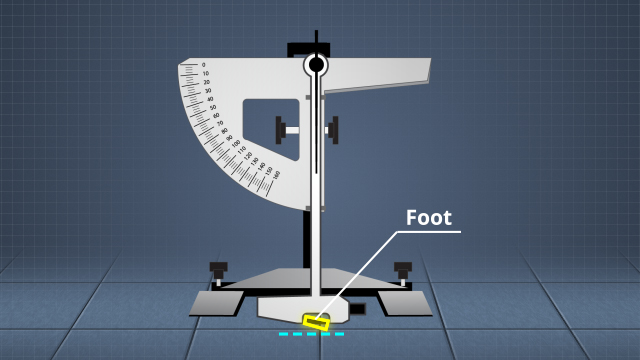 一个钟摆抗滑测试仪拖着一个标准的橡胶“脚”在坚硬的表面上